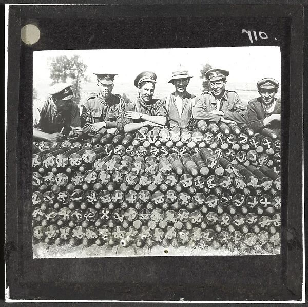 Soldiers lean on pile of 18-pounder shells nr Becourt Wood