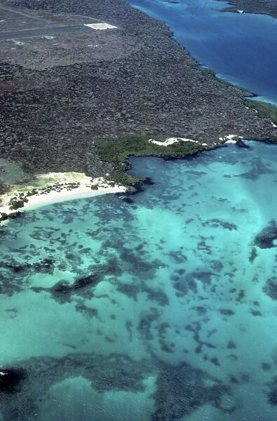 Aerial view of SW corner of Baltra with shallows and end of old WWII runway. Baltra, Galapagos Islands