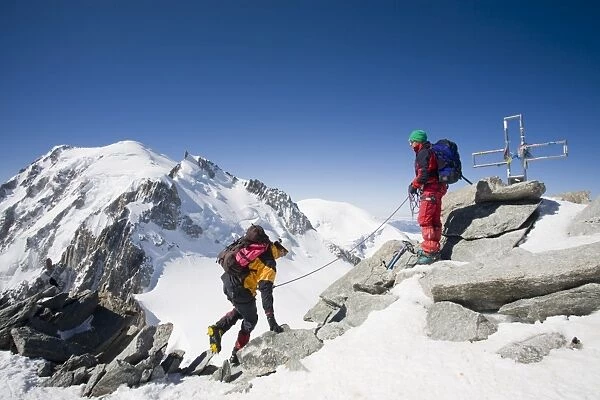 Climbers on the summit of the 4000 metre peak of Mont Blanc Du Tacul above Chamonix France