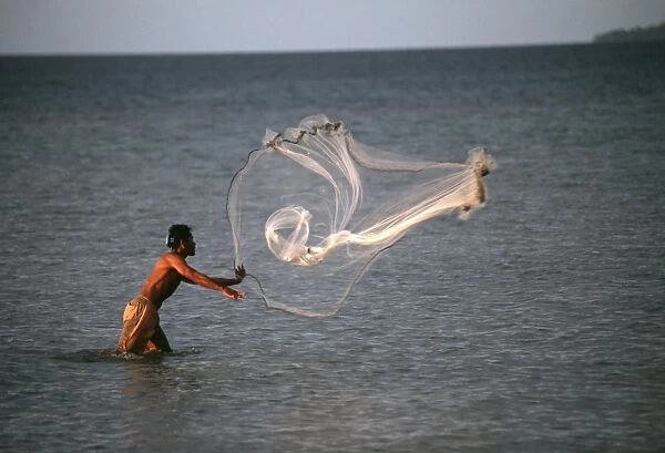 Fisherman throws net. Truk Lagoon
