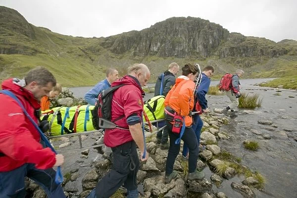 The Langdale Ambleside Mountain Rescue Team stretcher an injured hiker of the Langdale Fells in the Lake District