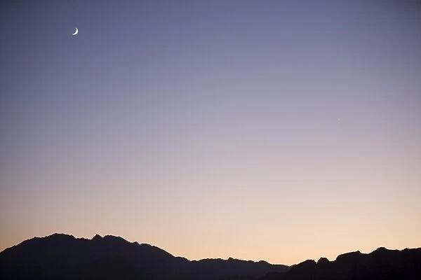 A new moon over the mountains of the Sinai Desert in Egypt