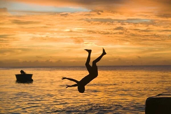 Tuvaluan children leaping into the sea on Funafuti atol Tuvalu