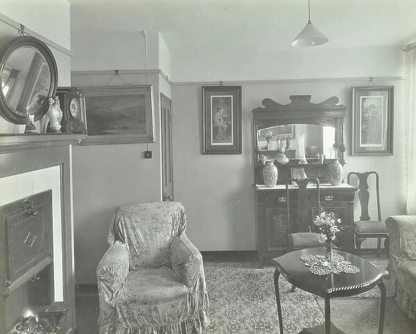 East Hill Estate: interior of tenement, showing armchair, table, mirror and cabinet