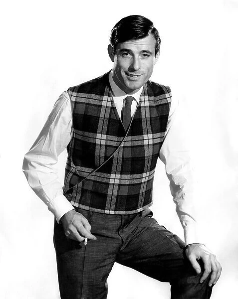 Model Peter Anthony wearing tartan patterned waistcoat, smoking a cigarette