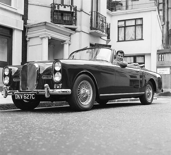Tony Curtis, american actor poses for pictures in his Alvis TE21 motorcar in