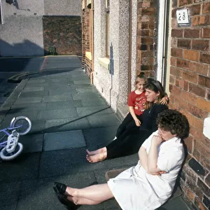 Sitting on the pavement outside a house in Barrow in Furness