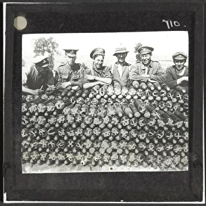 Soldiers lean on pile of 18-pounder shells nr Becourt Wood