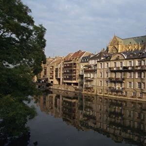 Reflections in water of buildings, with the Cathedral of St. Etienne in the background