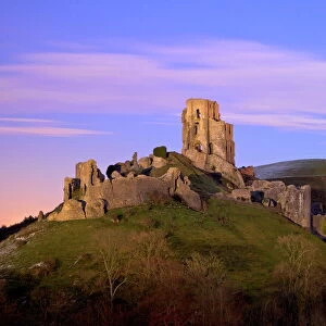 The ruins of the 11th century Corfe Castle after sunset, near Wareham, Isle of Purbeck