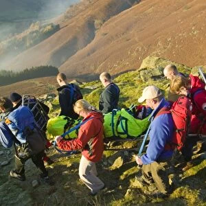 The Langdale Ambleside mountain Rescue Team stretcher an injured walker of the Lake District fells UK