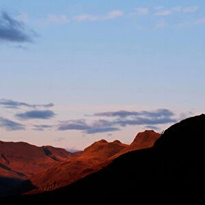 The moon over Bowfell and the Langdale Pikes in the Lake district UK