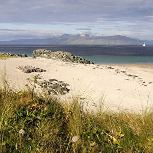 SCOTLAND, Argyll, Isle Of Iona, Grasses and sandy beach with views of Mull