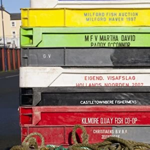 Stack of plastic fish boxes on quayside, Aberystwyth, Ceredigion, Wales, January