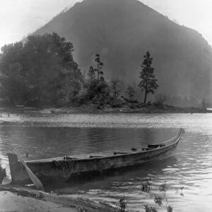 CANOE, c1910. A Native American canoe on the riverbank of the Columbia River with