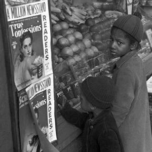 POVERTY: CHILDREN, 1937. Children looking at food through a storefront window, Washington, D