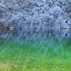 Colourful water with reflections in snow, Plitvice Lakes National Park, Lika, Croatia