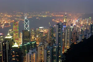 Hong Kong's modern skyline overlooking Victoria harbour and Kowloon peninsula at night, Hong Kong Hong Kong's modern skyline overlooking Victoria harbour and Kowloon peninsula at night, Hong Kong