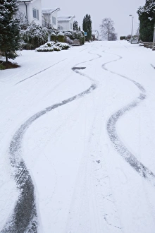 Skid marks in the snow from a car on a steep road in Ambleside UK Skid marks in the snow from a car on a steep road in Ambleside UK