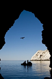 Zodiac approaching a cave at Isla San Pedro Martir in the midriff region of the Gulf of Zodiac approaching a cave at Isla San Pedro Martir in the midriff region of the Gulf of